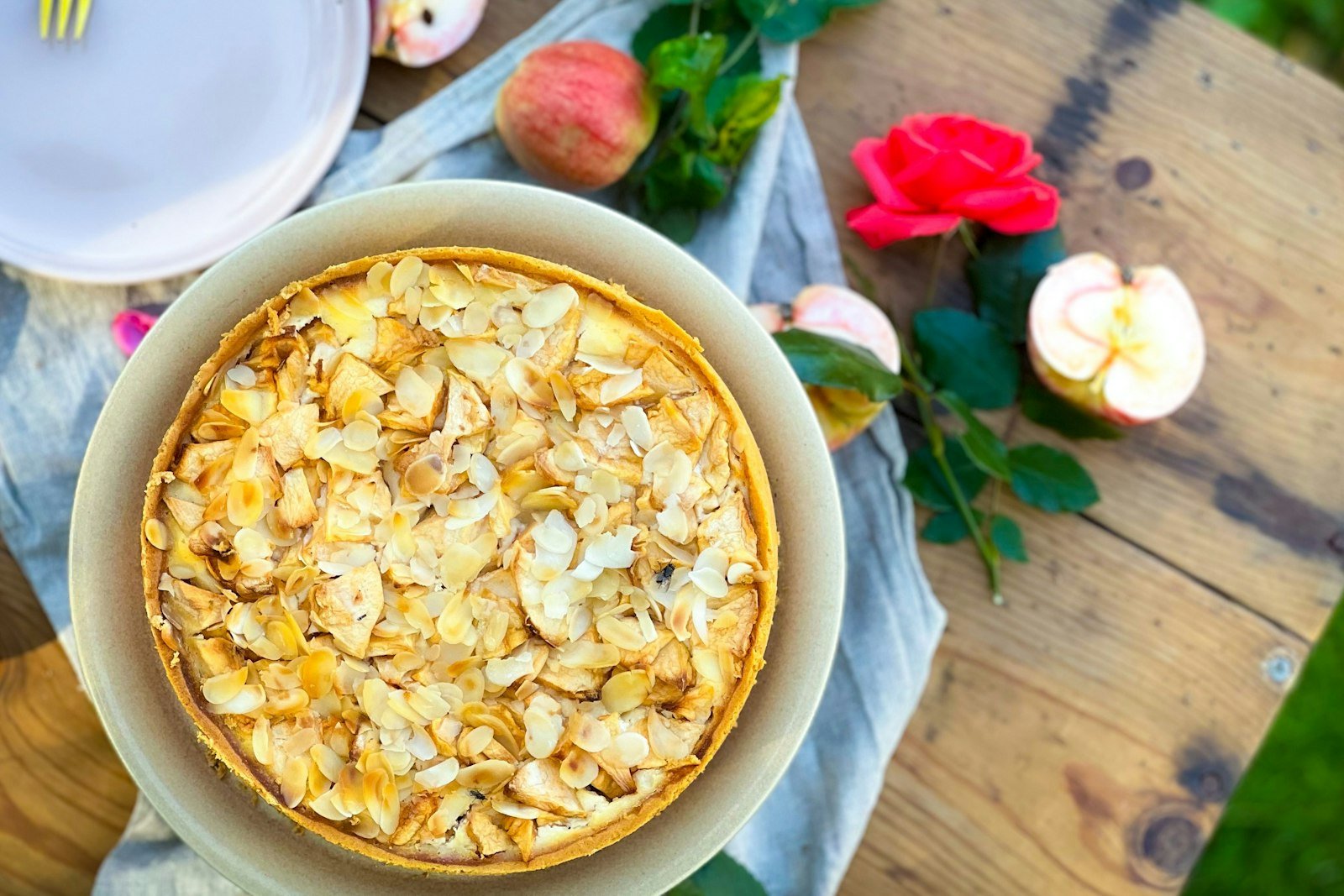 A spoonful of caramel apple dump cake with a golden buttery topping and a scoop of vanilla ice cream