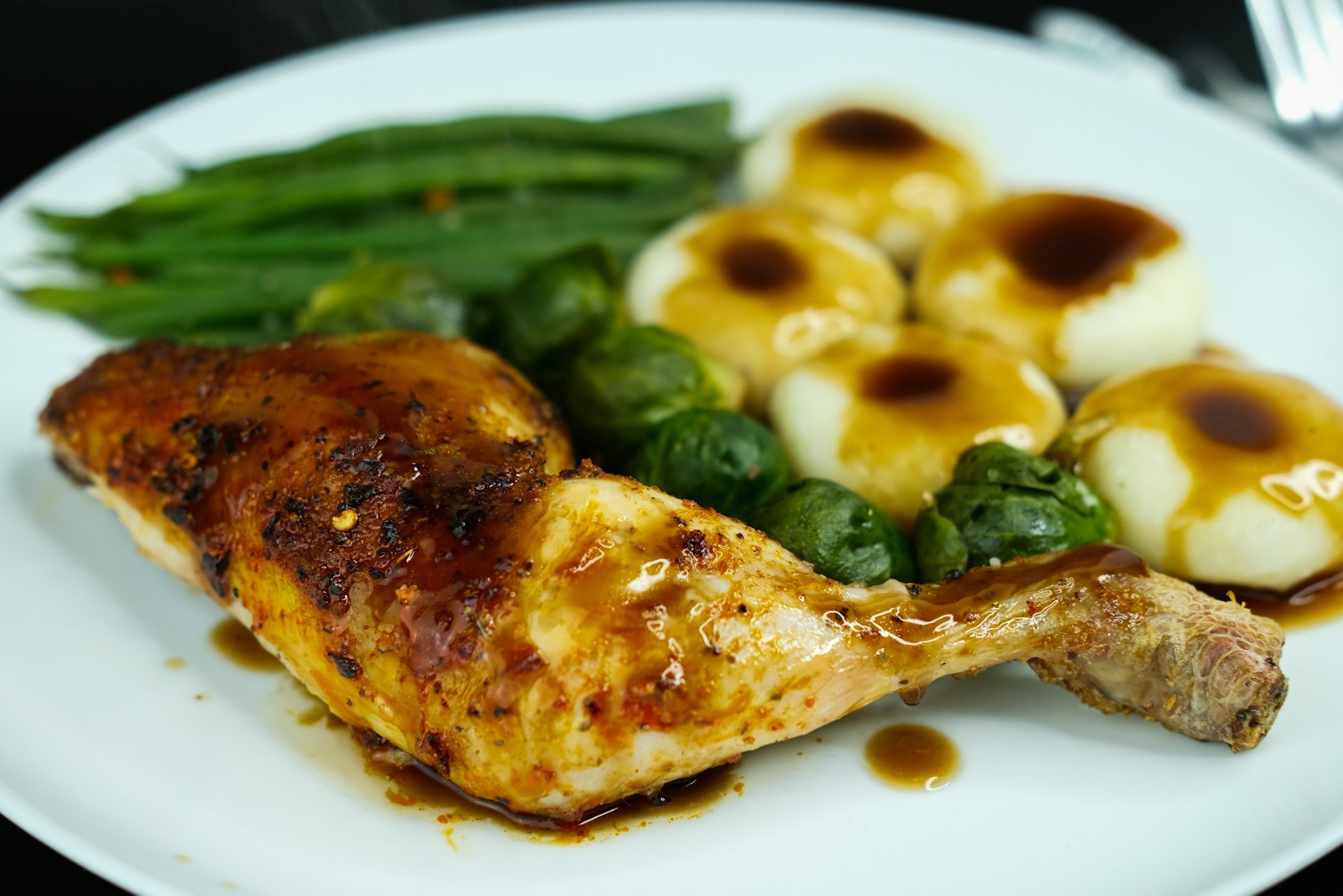 BBQ chicken leg served with mashed potatoes and green beans