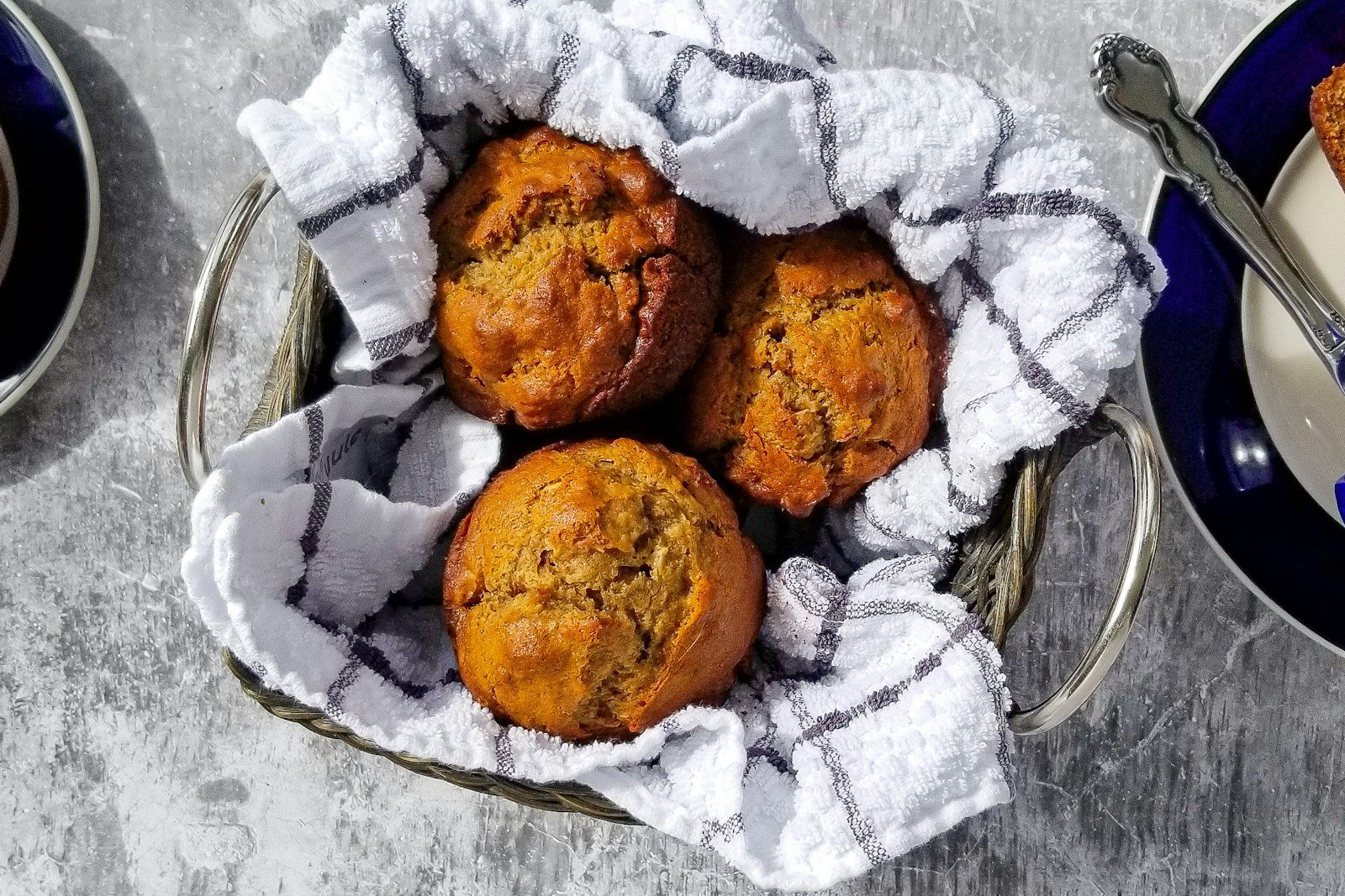 Slicing into a cooled loaf of pumpkin bread to reveal the soft, moist crumb