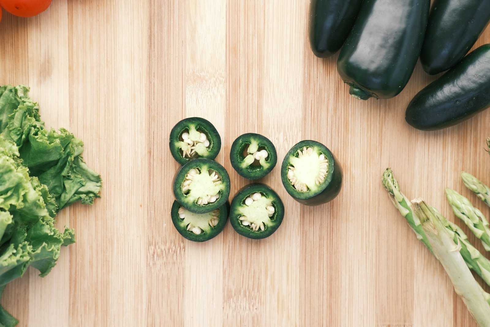 Stuffed jalapeno halves filled with the bacon and cheddar cream cheese mixture, ready for the oven