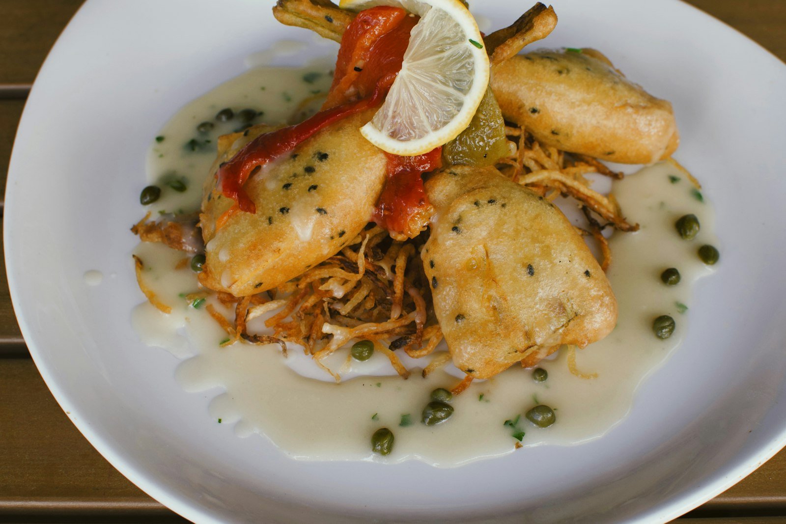 Golden chicken piccata cutlets in a glossy lemon butter caper sauce with lemon slices and fresh parsley