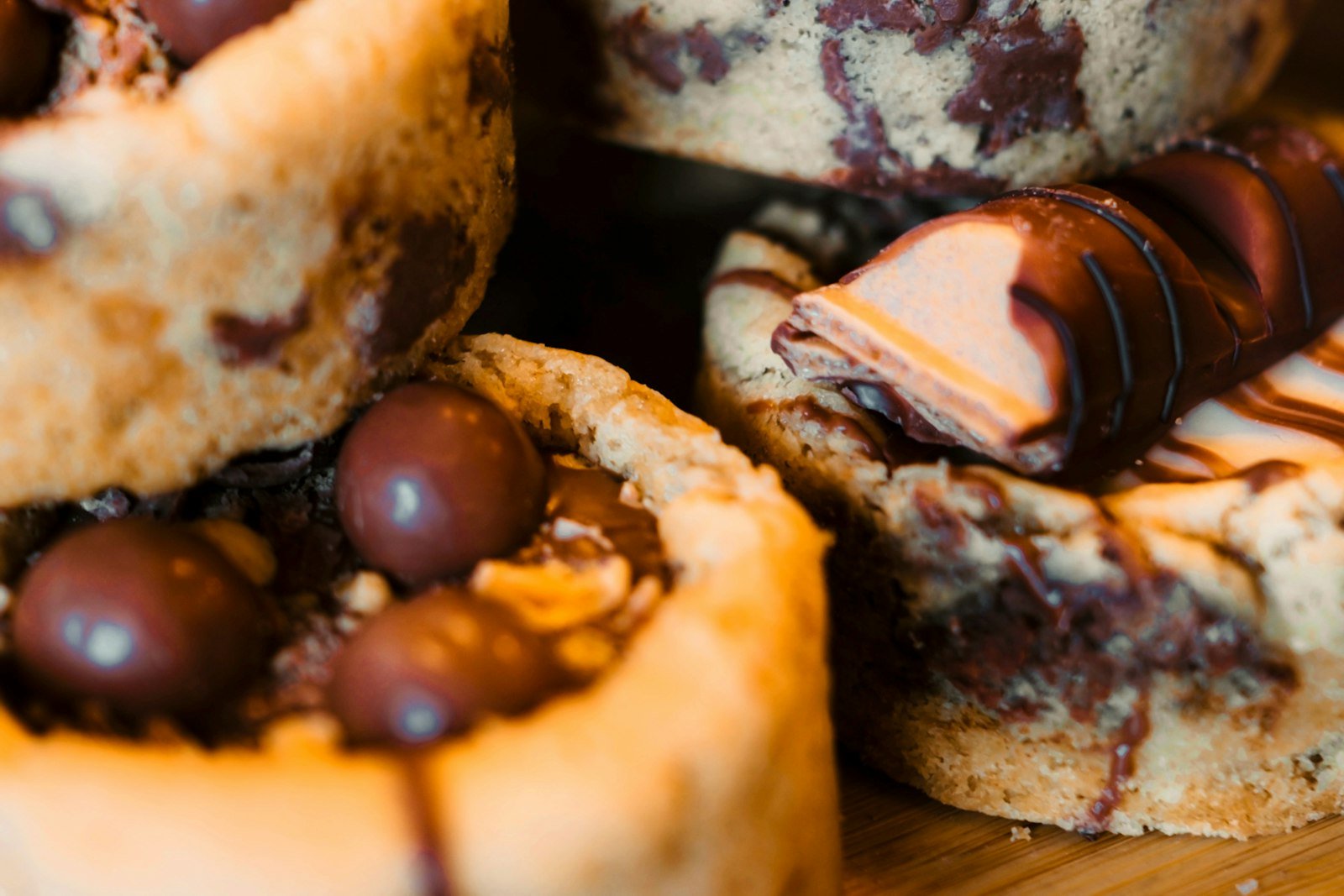 Chocolate chip cookie cups filled with chocolate ganache and fresh cranberries on a holiday platter