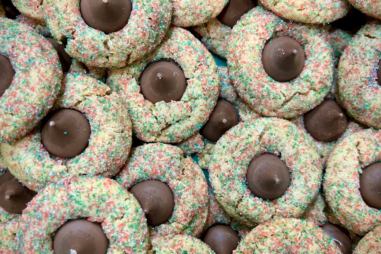 Chocolate peppermint thumbprint cookies filled with white chocolate ganache and crushed candy cane on a festive platter