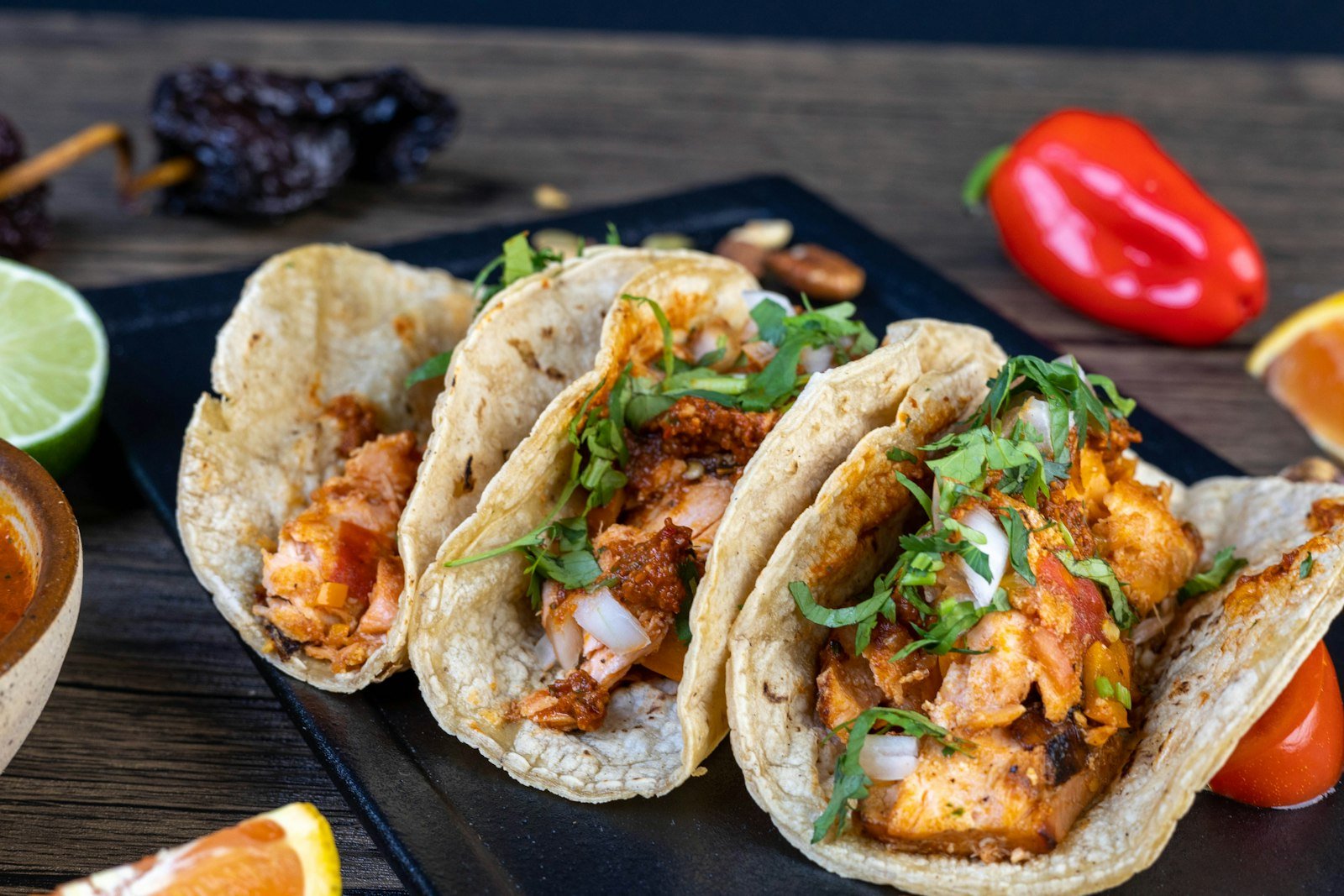Assembling crispy fish tacos with golden fish strips, lime slaw and chipotle crema in warm tortillas