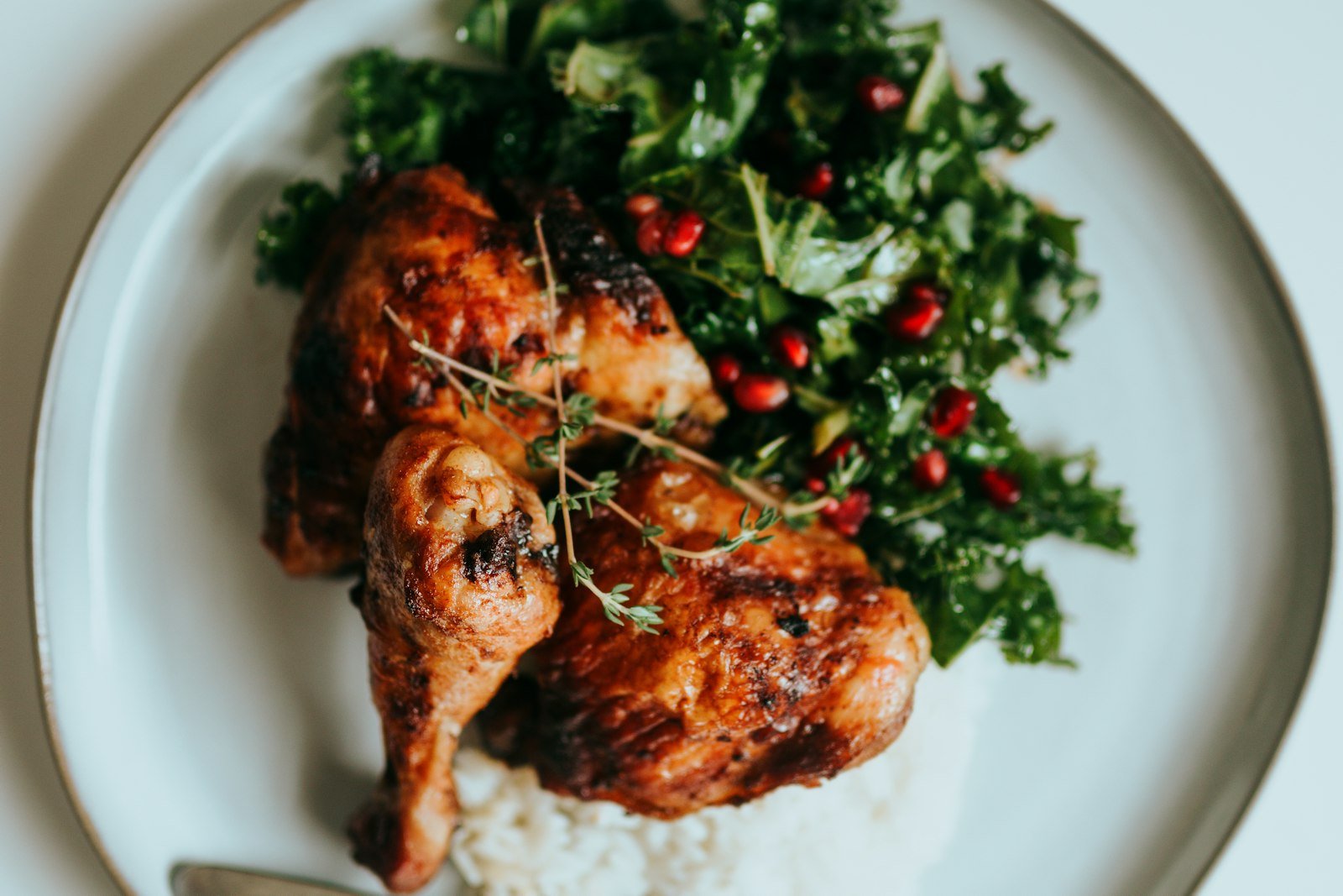Thighs roasting in a cast-iron skillet with a bubbling honey garlic glaze pooling around the golden skin