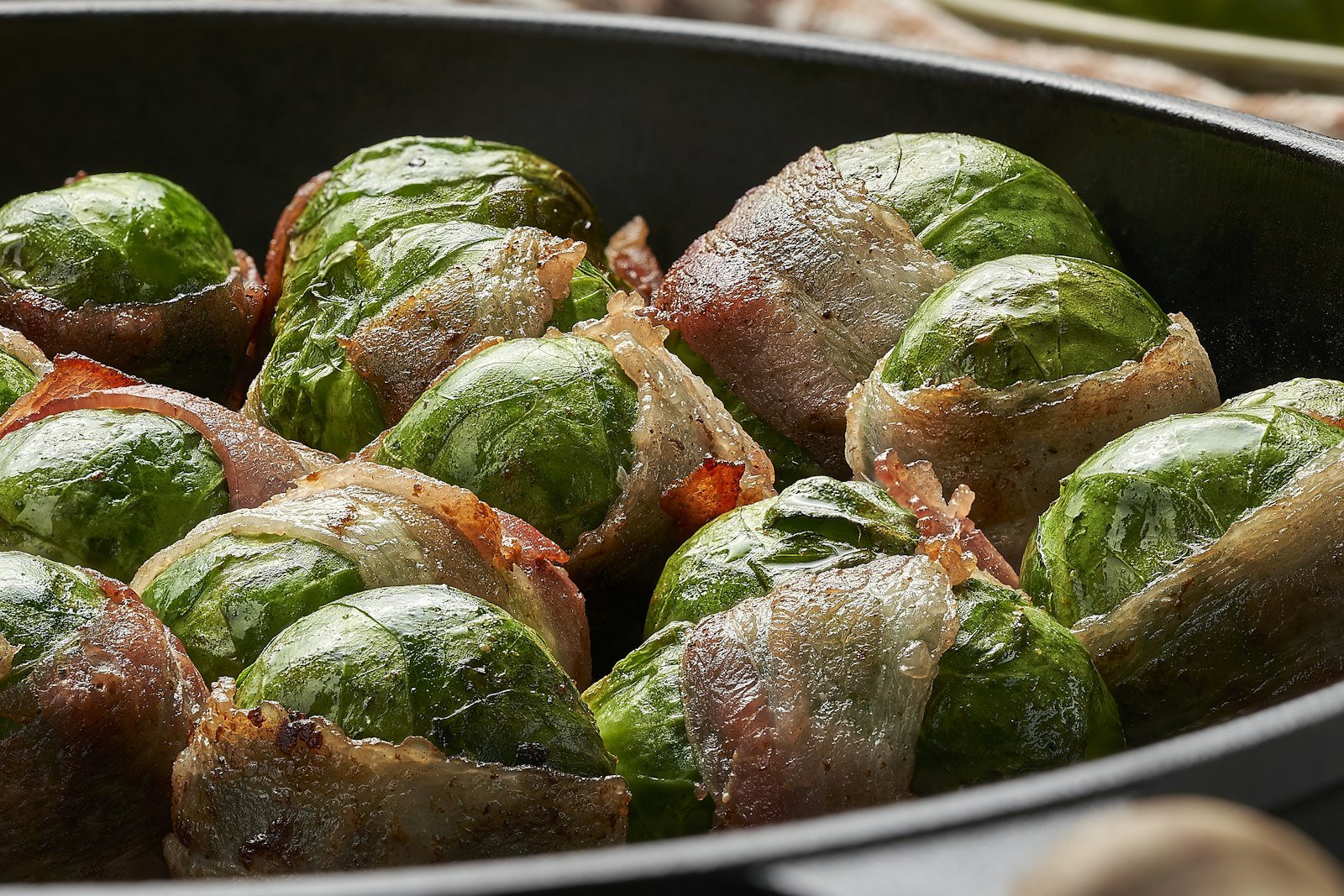 Close-up of crispy maple bacon Brussels sprouts with caramelized edges and toasted pecans