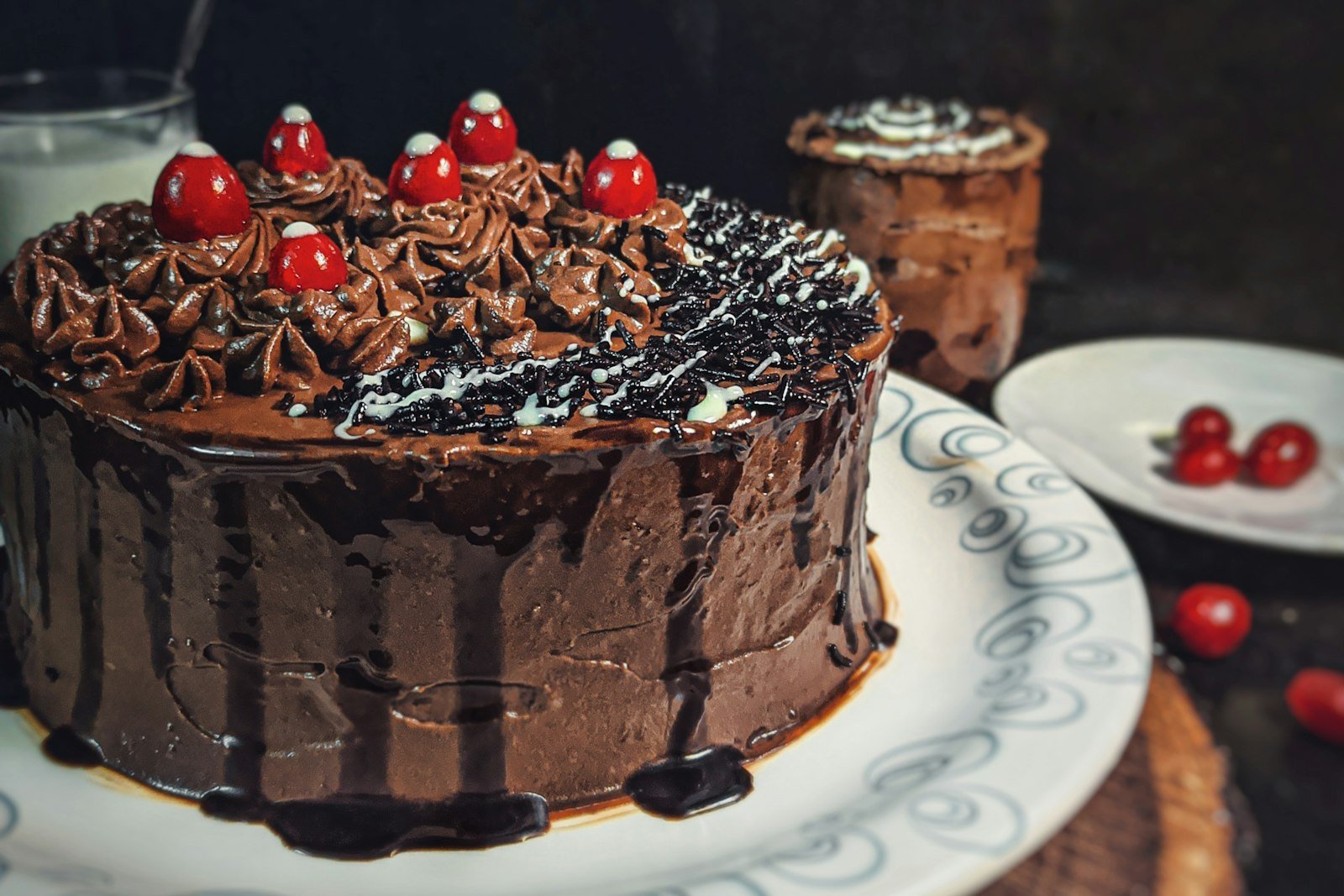 A one bowl chocolate cake in a 9x13 pan with swirls of creamy chocolate frosting and a square cut out to show the moist crumb