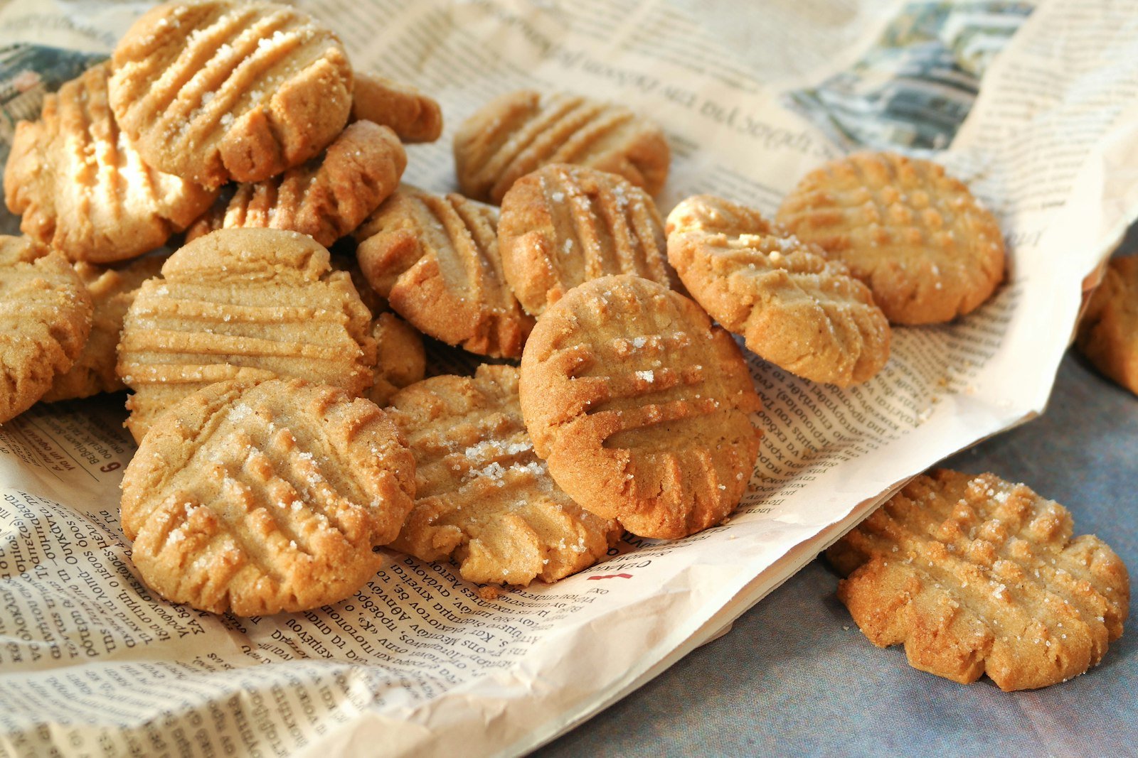 Pressing a criss-cross pattern into the dough balls and topping each with pretzel pieces